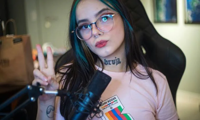 Adult content creator using laptop for social media copyright protection and online safety measures